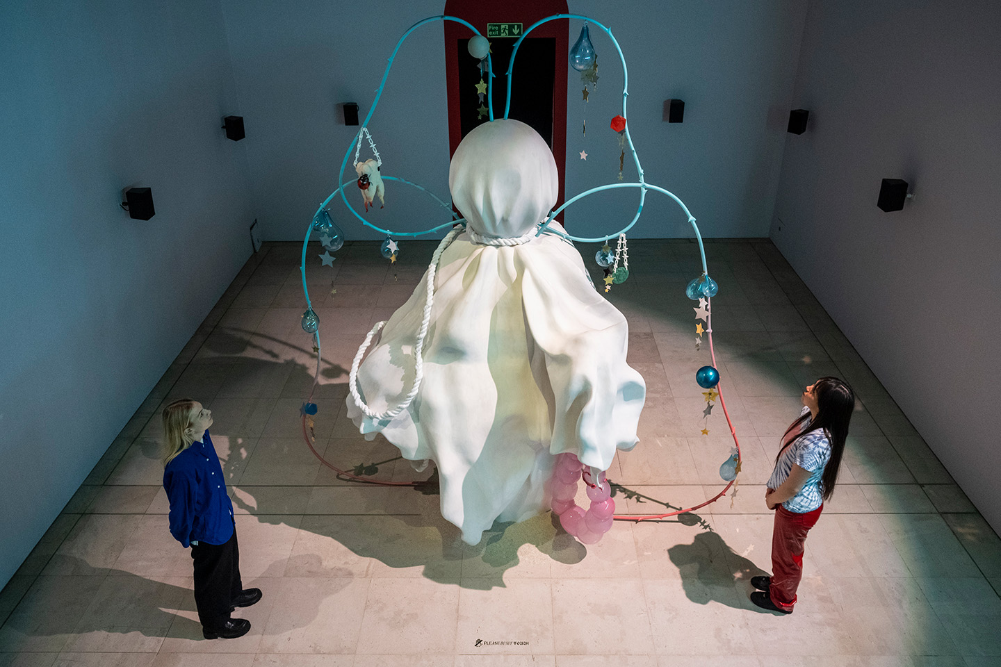 Installation view of Tai Shani's The Neon Heiroglyph, 2021, shows a large ghost like sculpture tied down with ropes