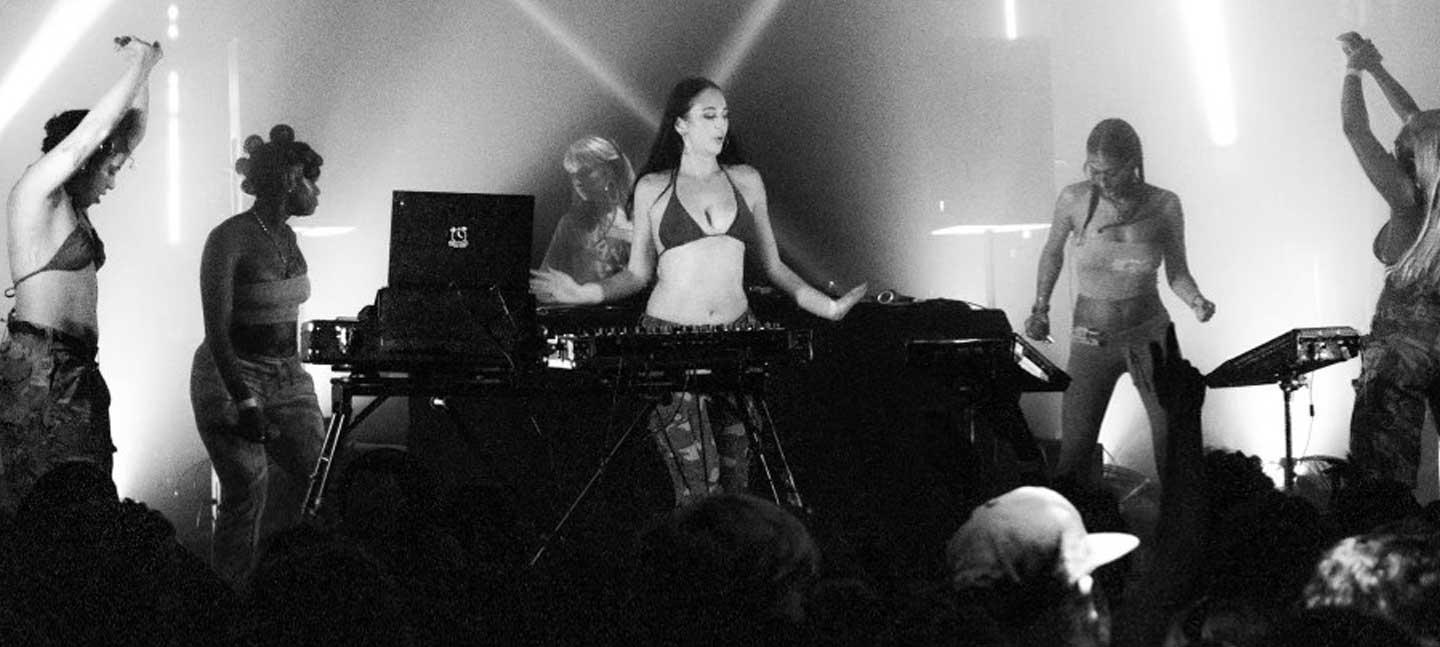 Sexy Lady Massive onstage in Brighton, October 2024. A black and white photo