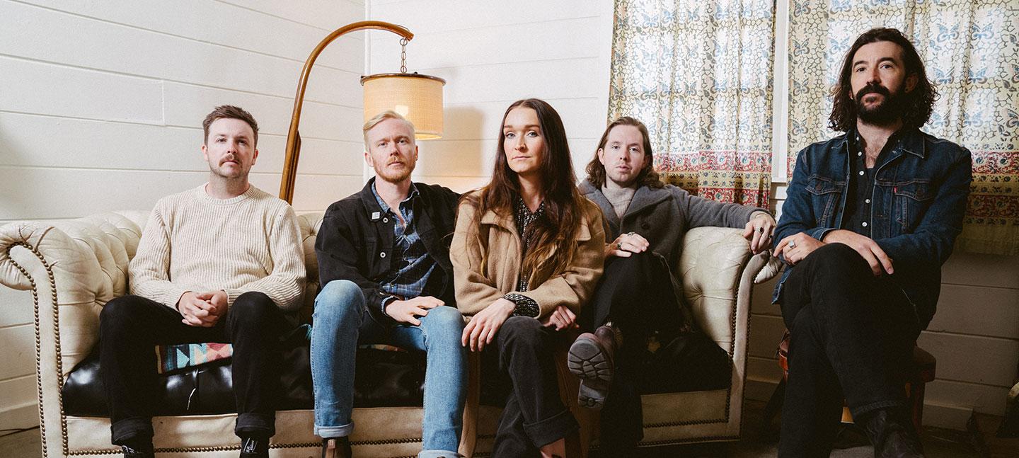 The Paper Kites sitting on a couch