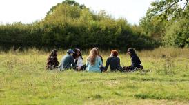 Young people sitting in a field