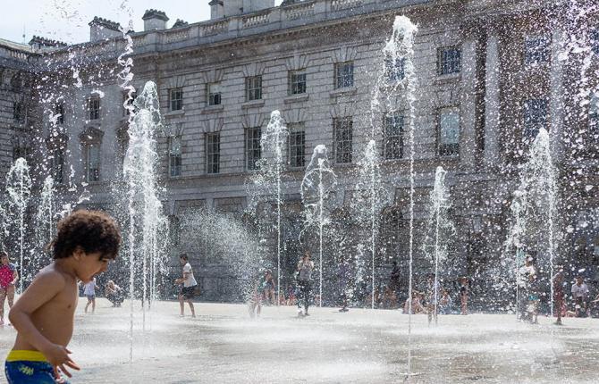 A child runs through the fountains in the Somerset House courtyard.